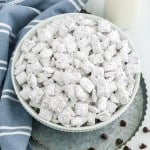 Large bowl of puppy chow, coated in powdered sugar. Blue and white linen present.