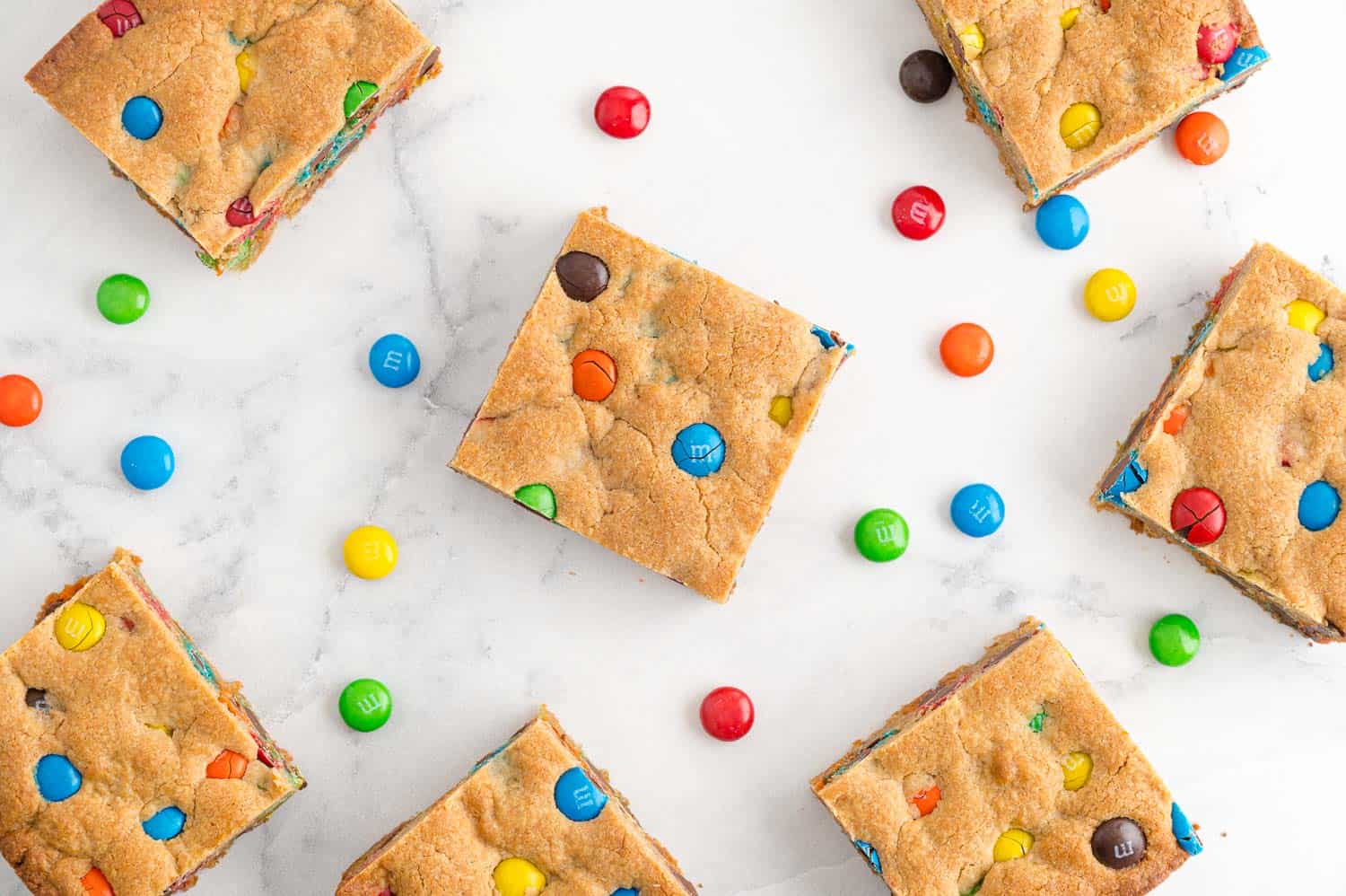 Bars on white surface, with M&Ms scattered around.