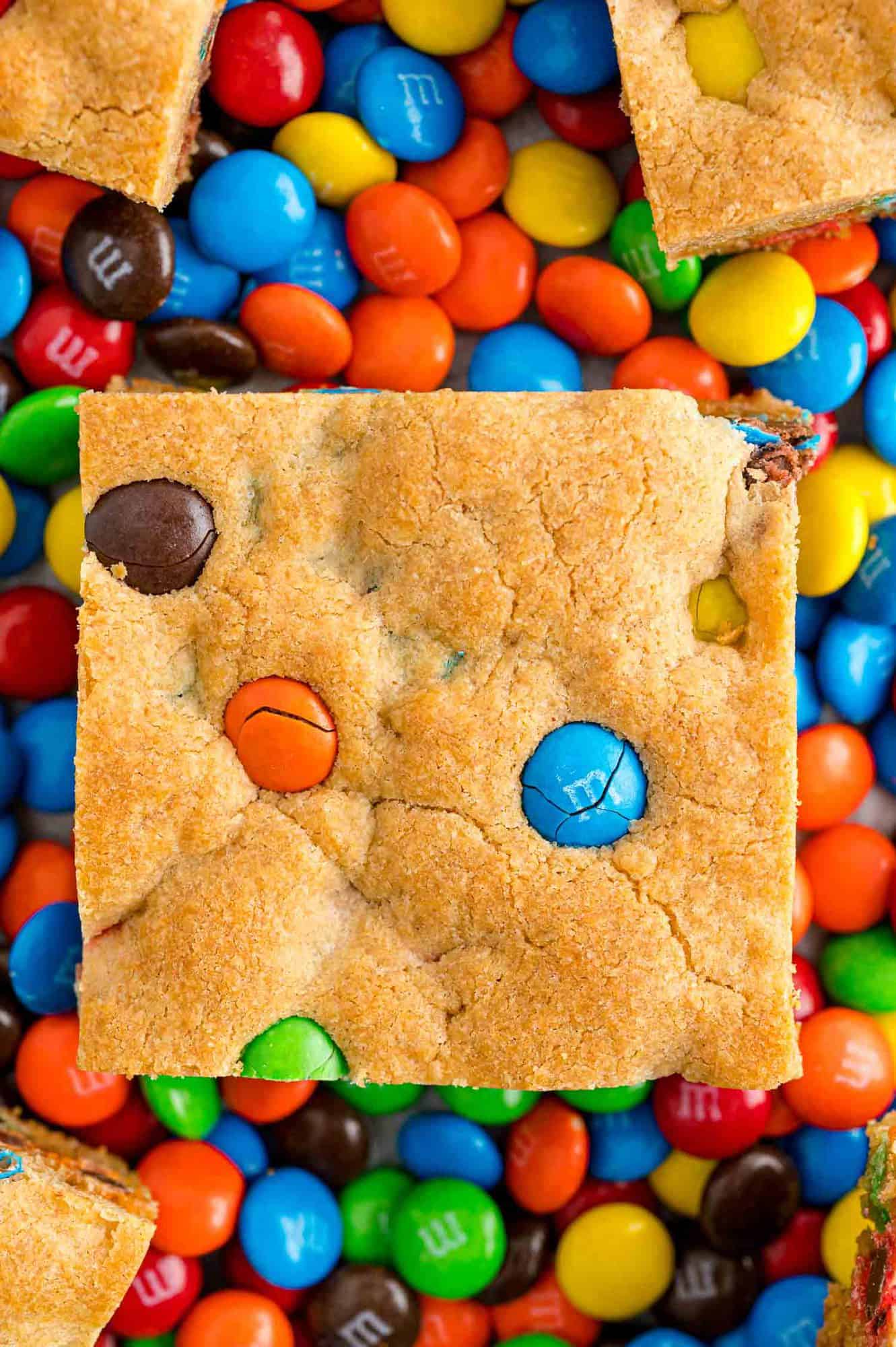 Cookie bar on top of a background of M&Ms.