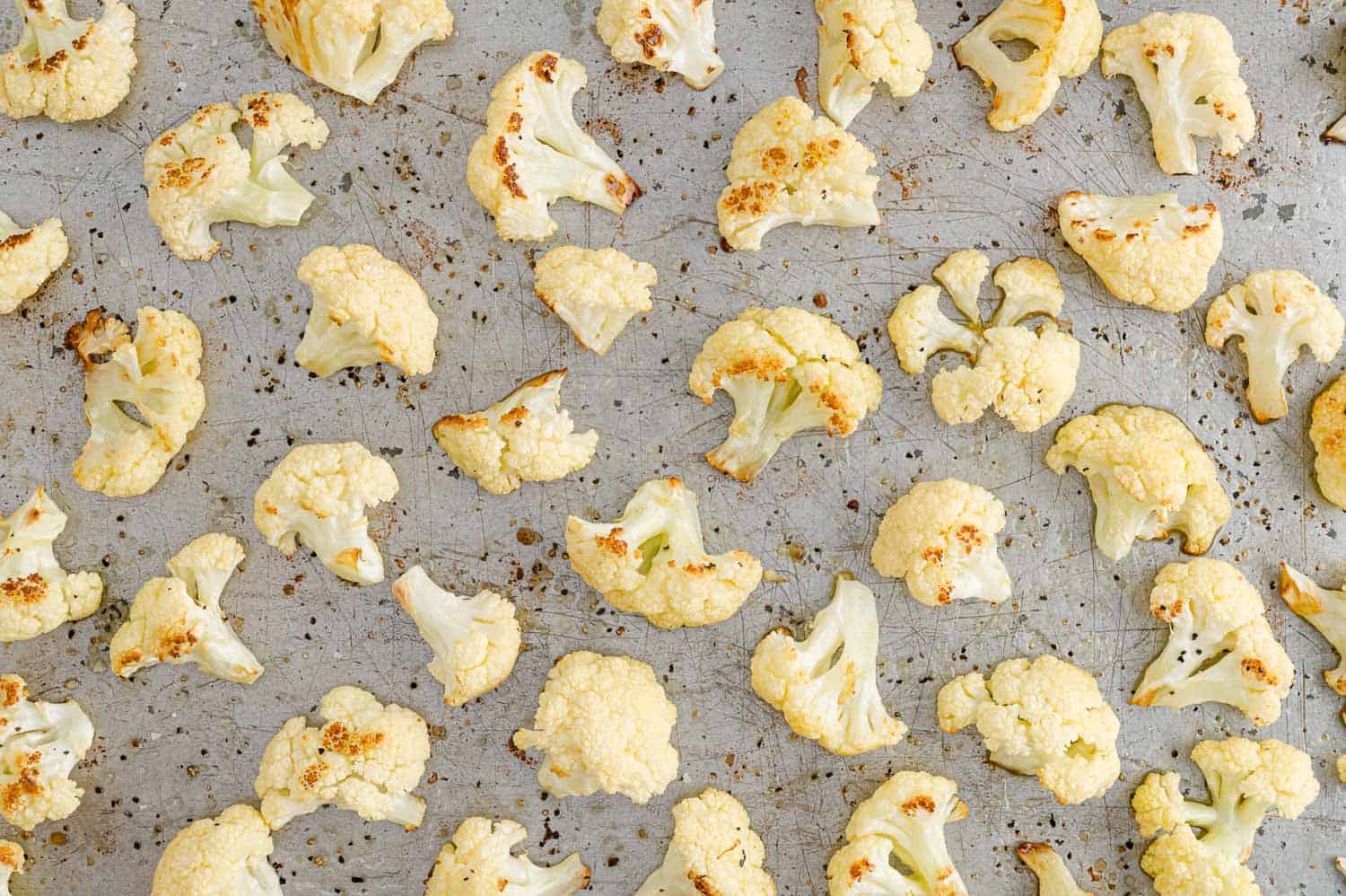 Roasted cauliflower on a baking sheet.