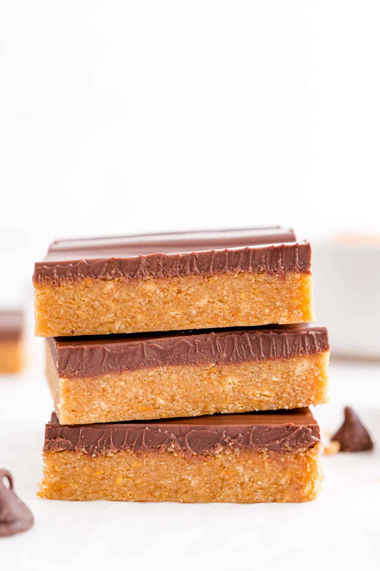 Stack of three no bake homemade reese's peanut butter bars.