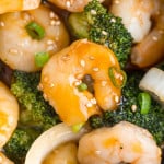 Shrimp and broccoli in a brown sauce, sprinkled with sesame.