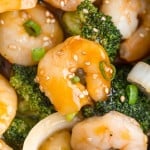 Shrimp and broccoli in a brown sauce, sprinkled with sesame.