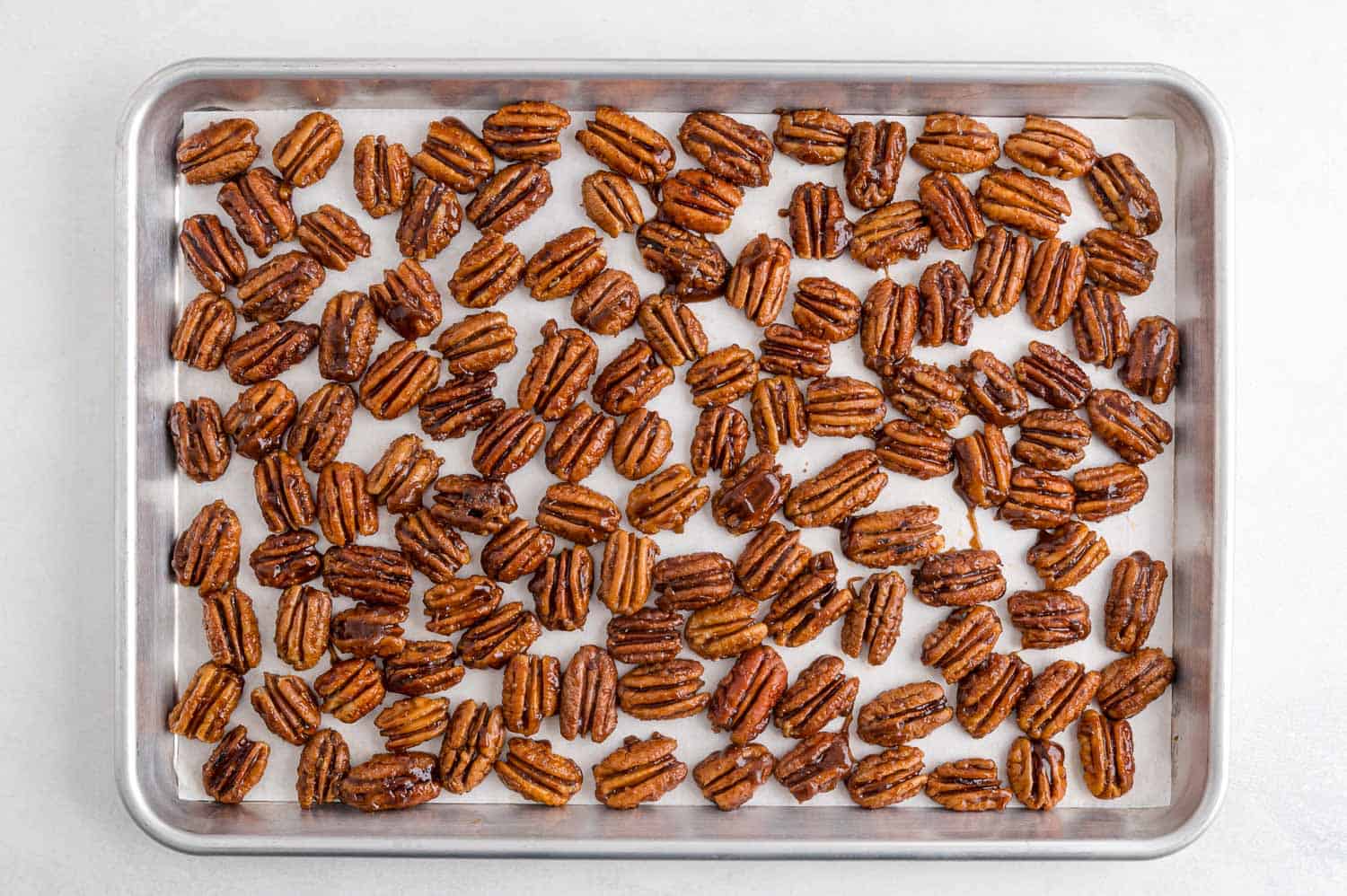 Spiced pecans on a sheet pan.
