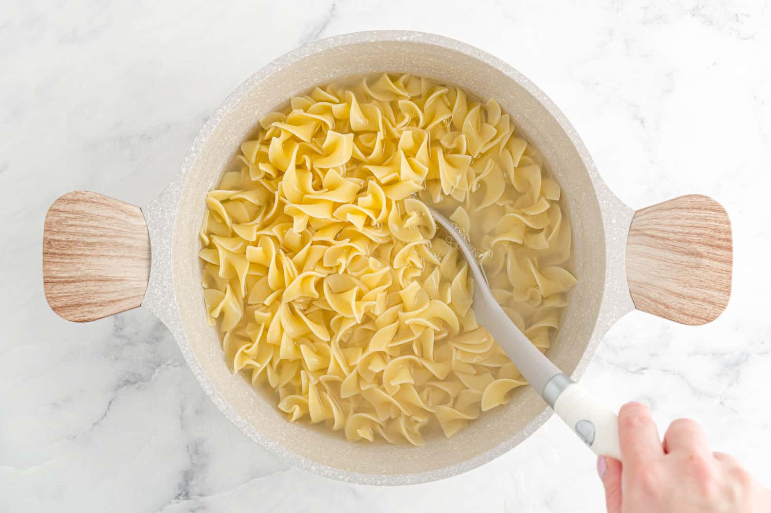 Cooked pasta in pot with water.