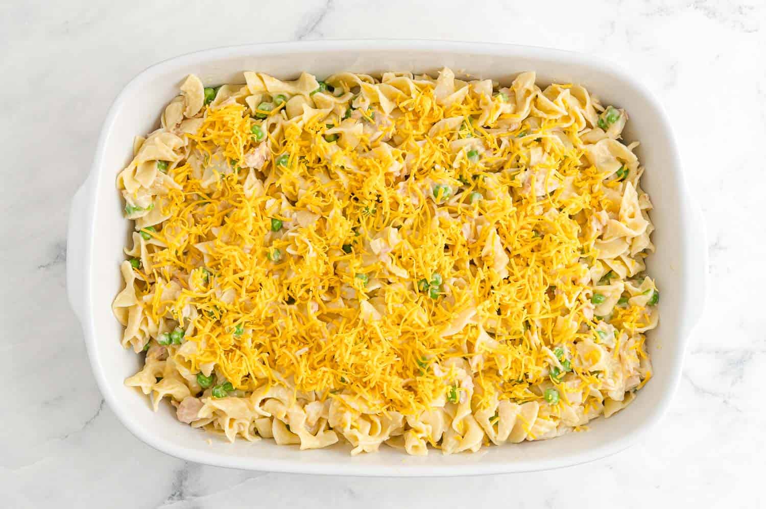 Unbaked casserole in a white dish.