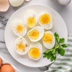 Plate of boiled eggs with pepper and parsley.
