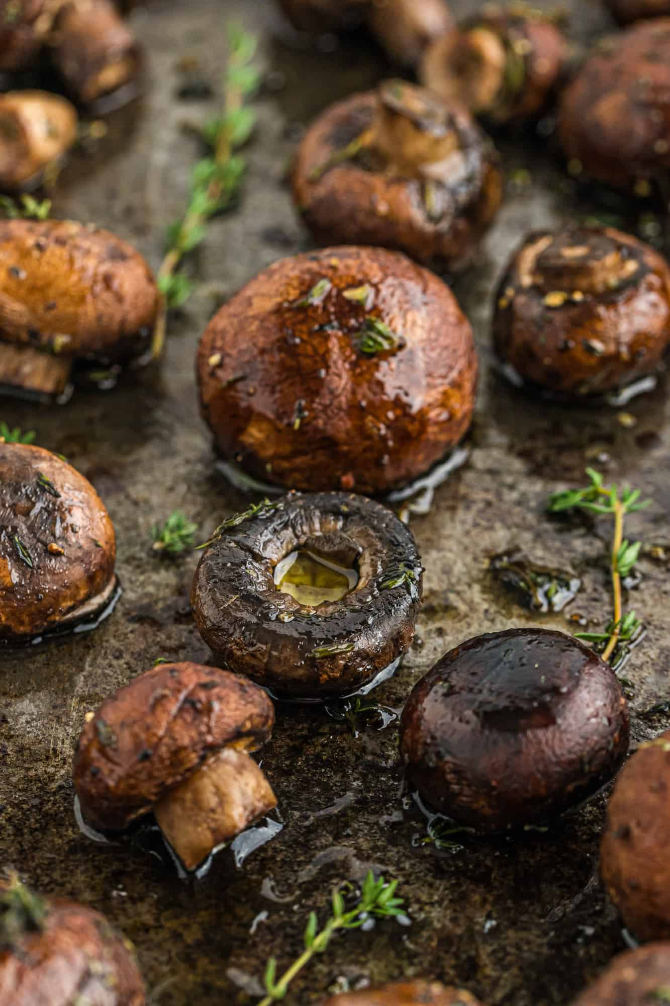 Mushrooms that have been roasted on a baking sheet.