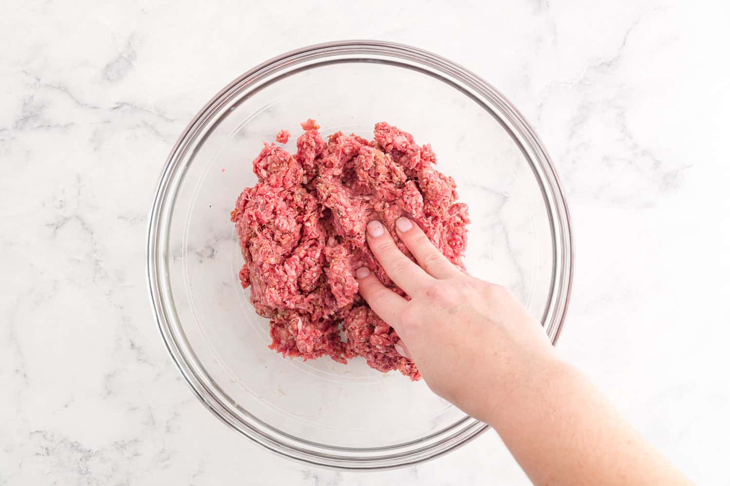 Ingredients being mixed by hand.