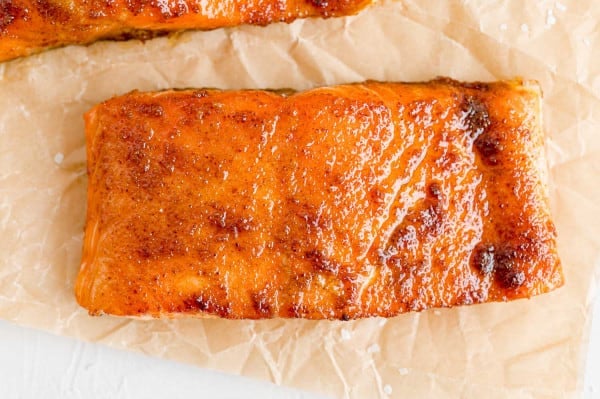 BBQ salmon fillet on a piece of parchment paper.