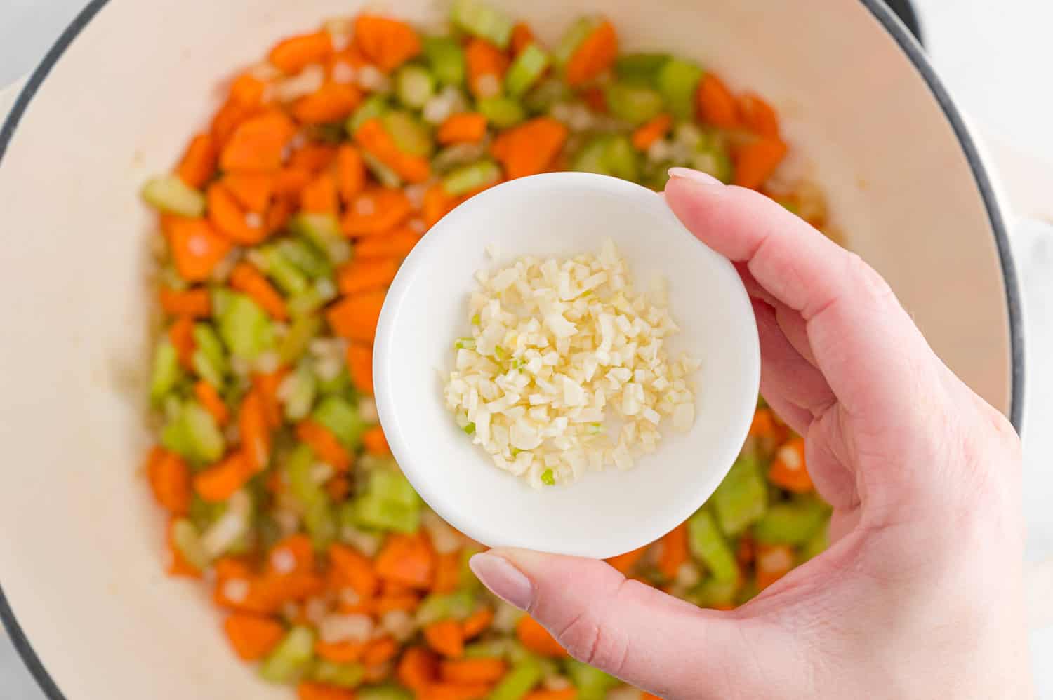 Garlic being added to vegetables.