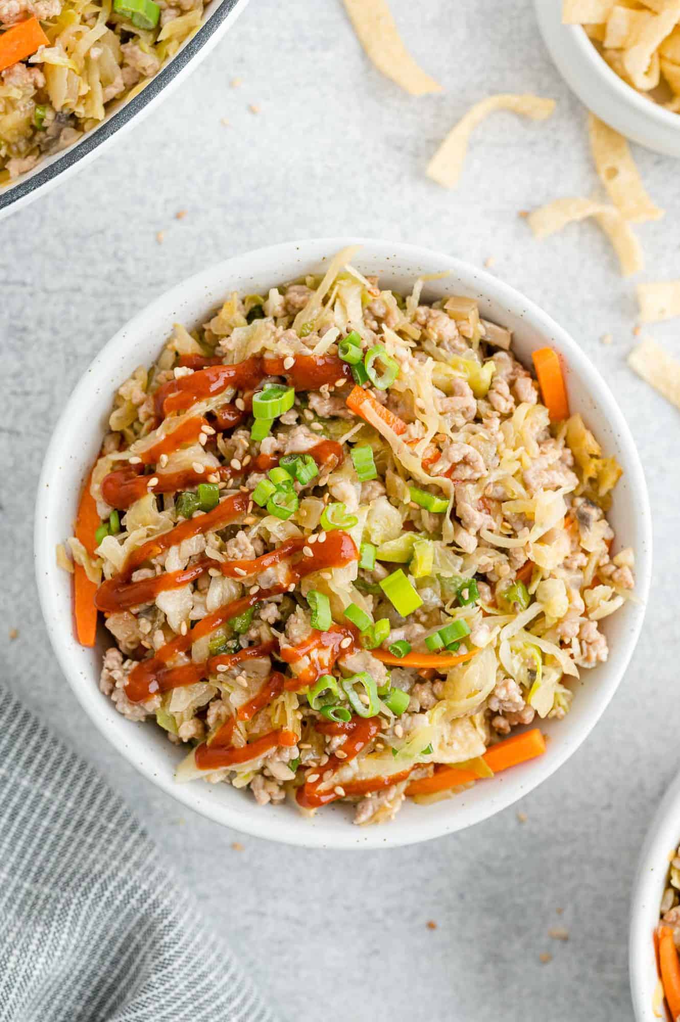 Egg roll in a bowl with toppings.