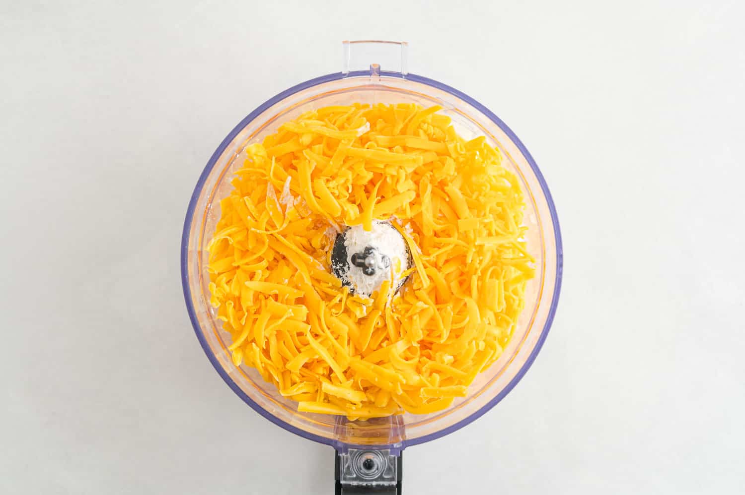 Shredded cheese in a food processor.