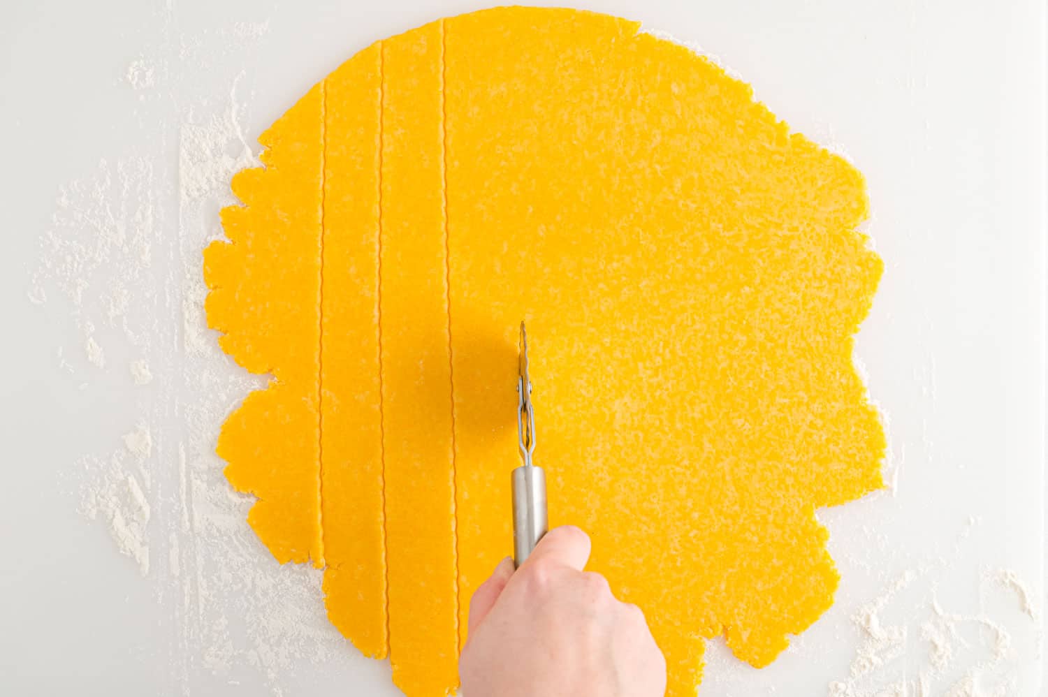 Dough being cut into small squares.