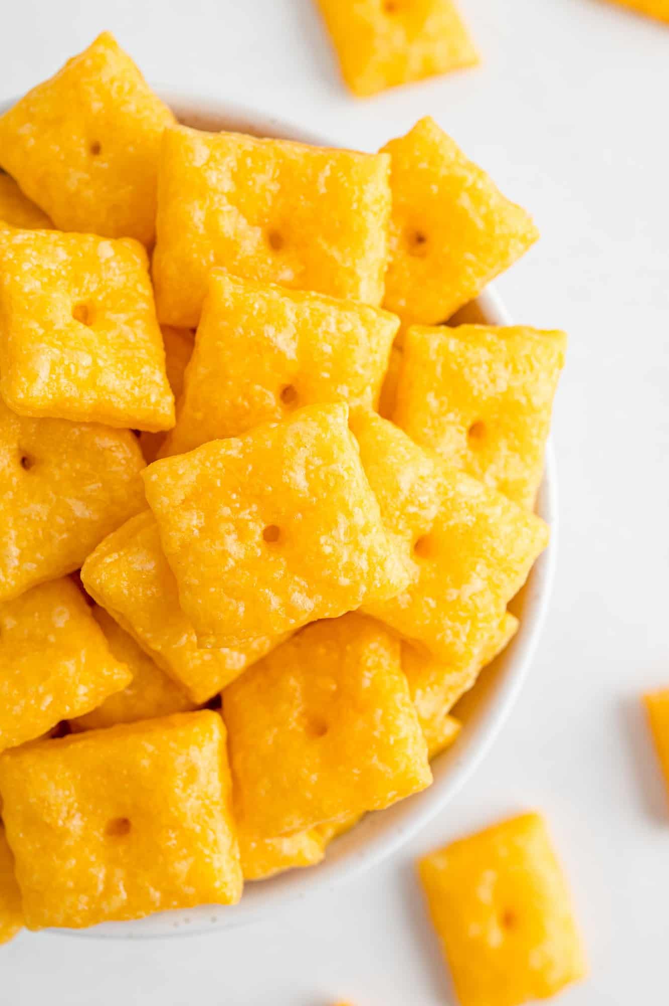 Overflowing bowl of homemade cheez-it crackers.