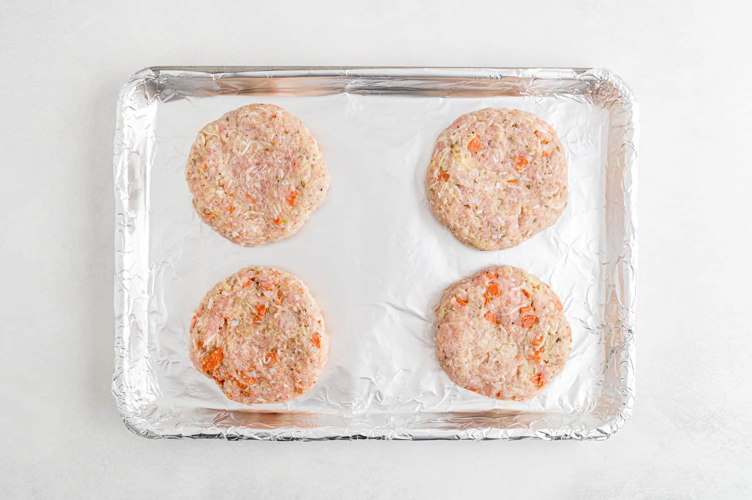 Uncooked turkey burgers.