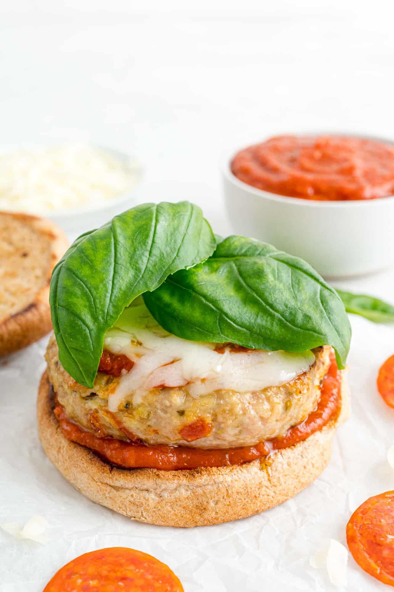 Turkey burger topped with mozzarella and basil.