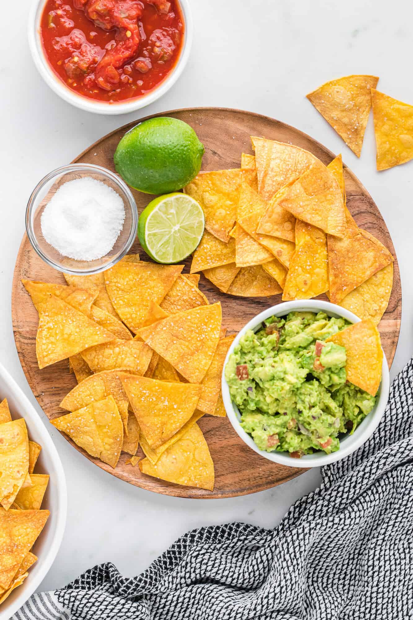 Baked tortilla chips with guacamole and salsa.