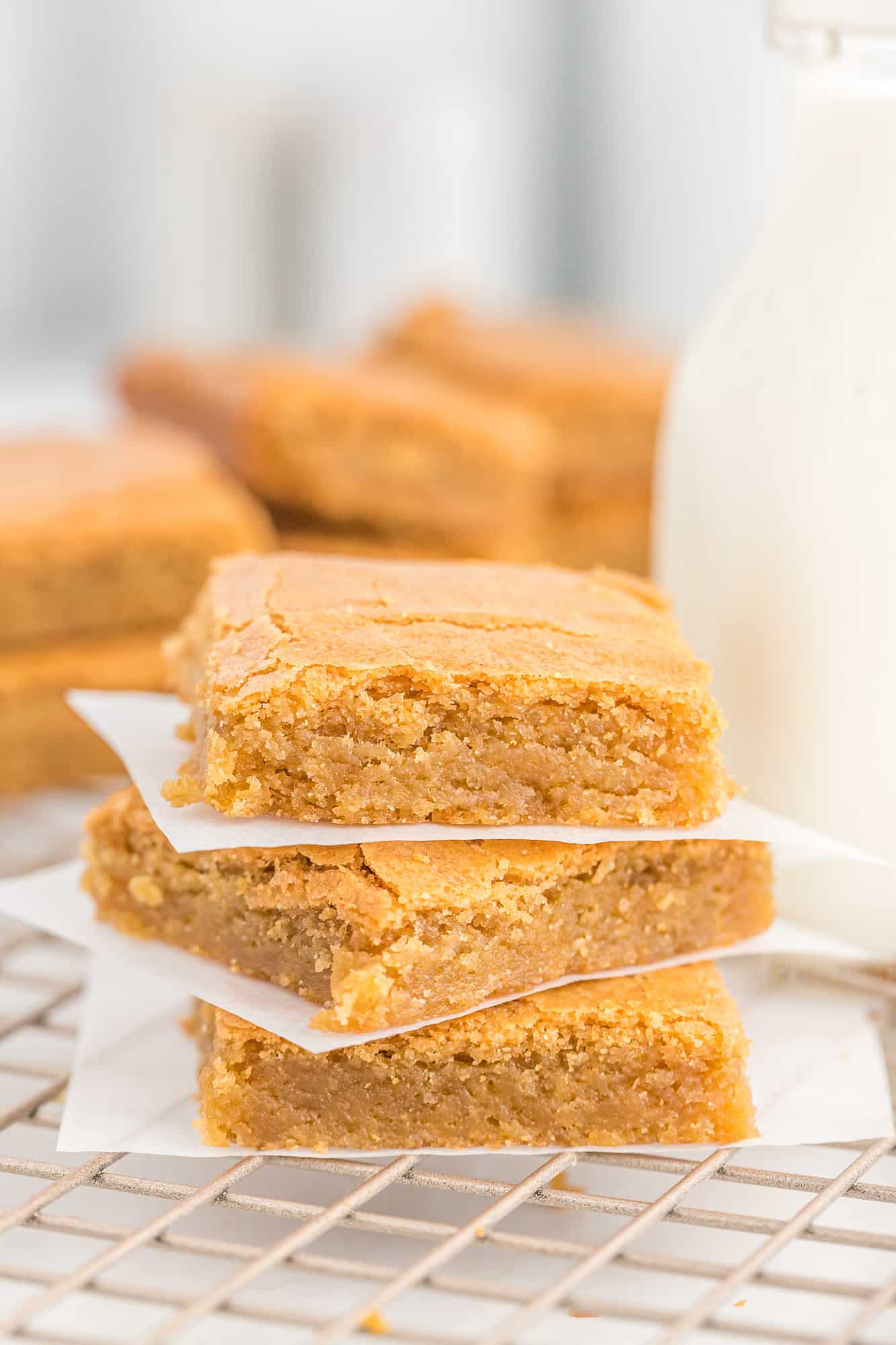 Blondies stacked three high with parchment between each.