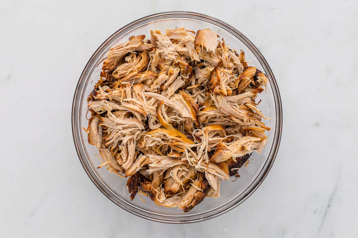 Shredded chicken in a bowl.