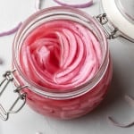 Overhead view of jar of pickled red onions.