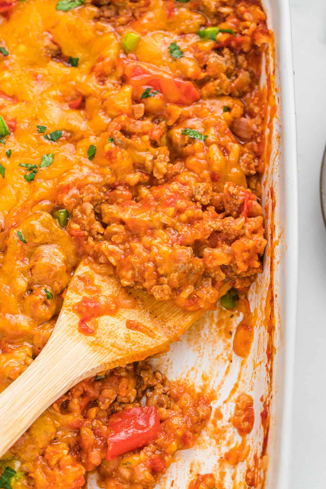 Casserole dish of tomatoes, peppers, rice, and ground turkey.