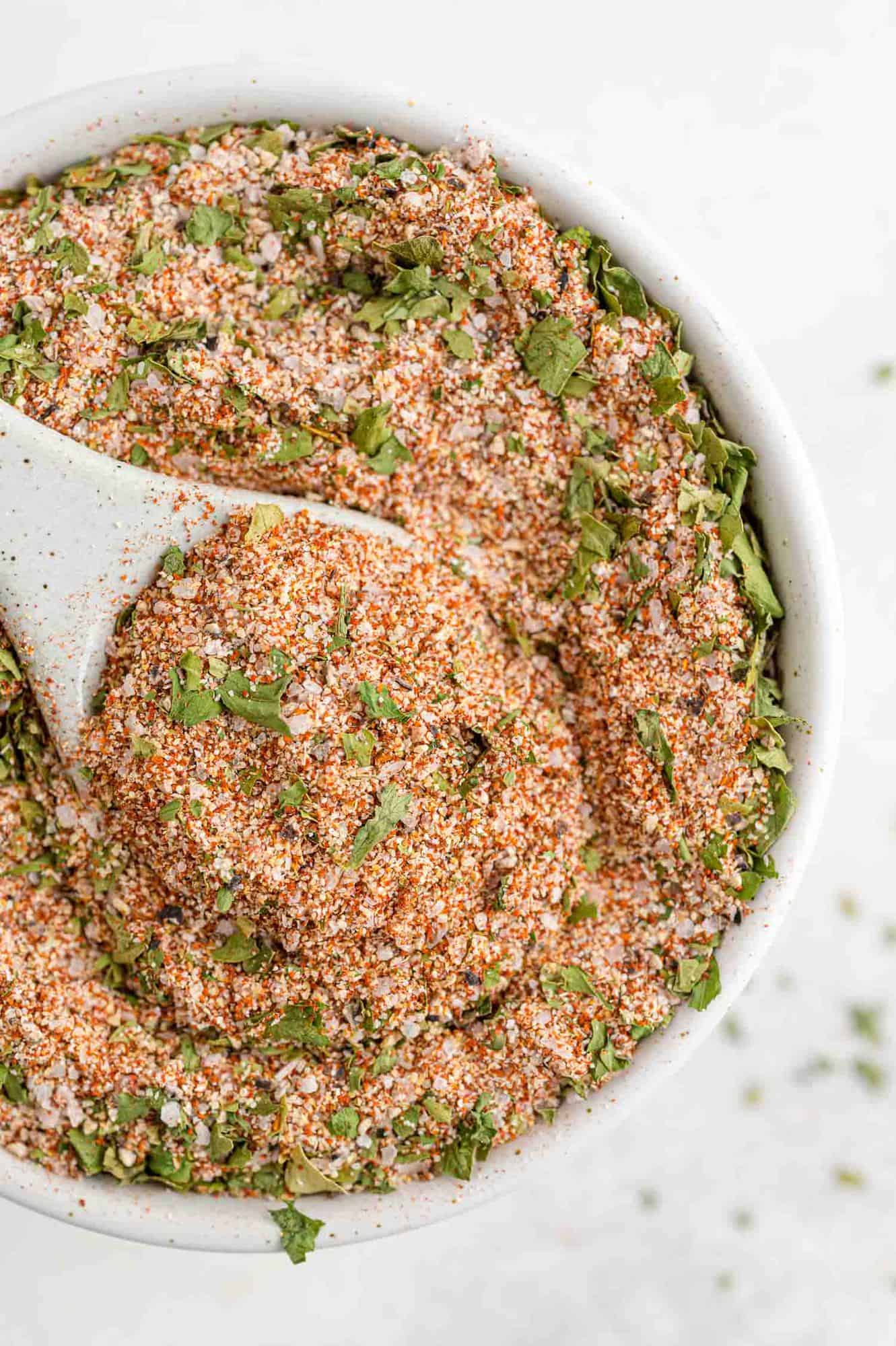 Seasoning in a bowl with a measuring spoon.