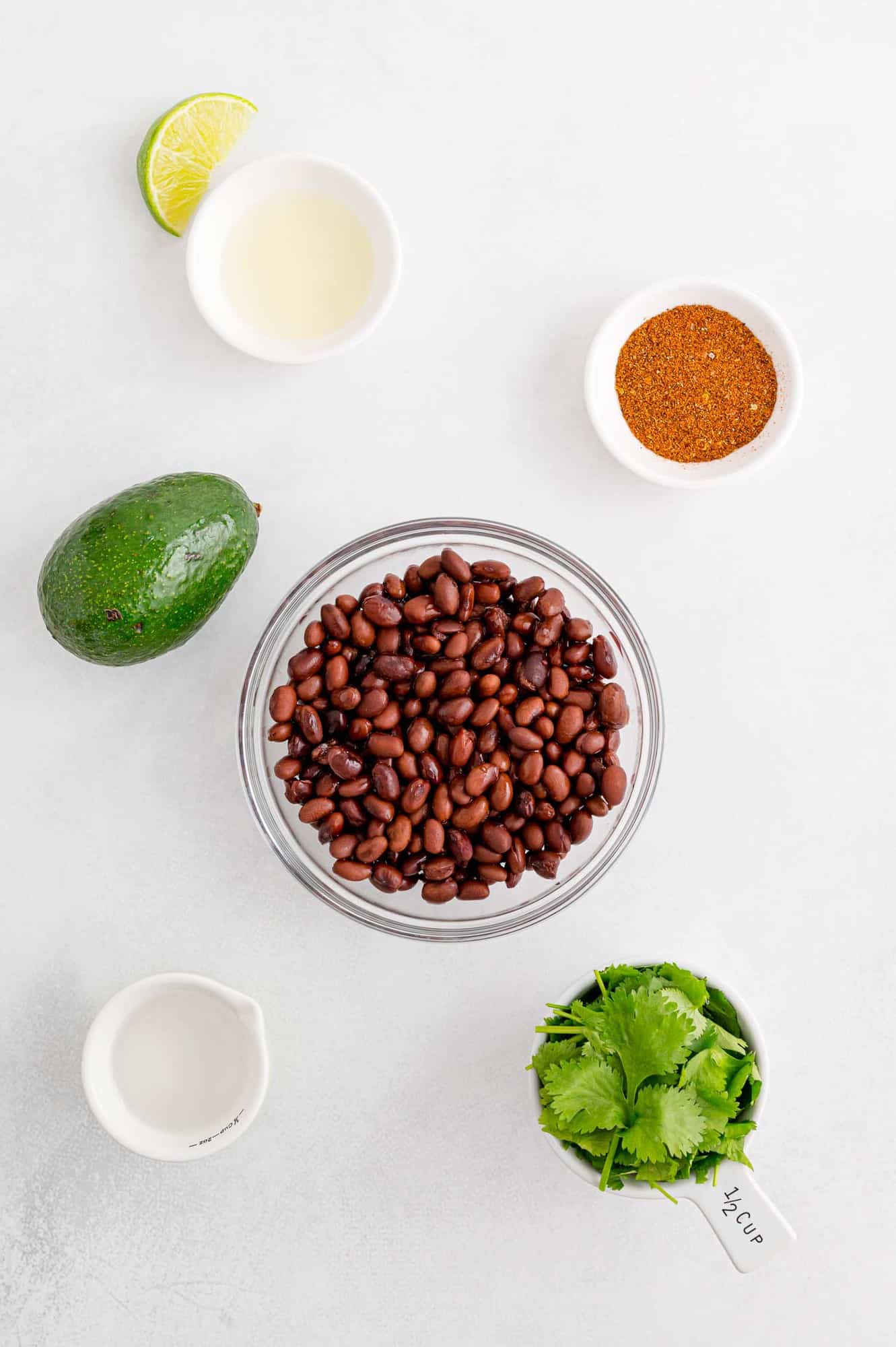 Ingredients in separate bowls, including black beans.