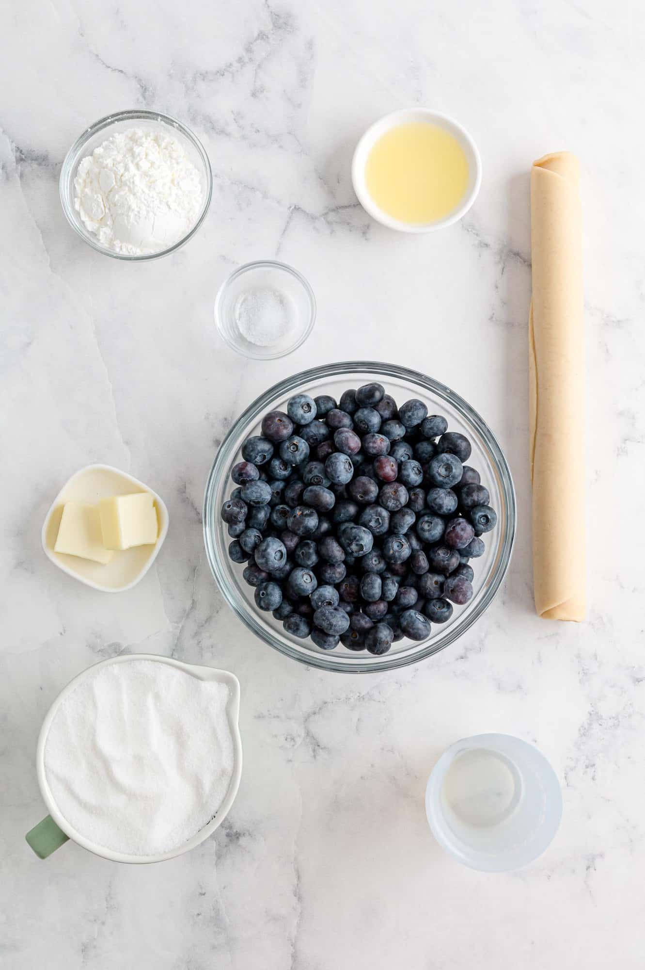 Ingredients in separate bowls, including fresh blueberries.