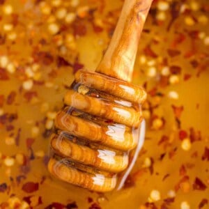 Close up of hot honey and honey dipper.