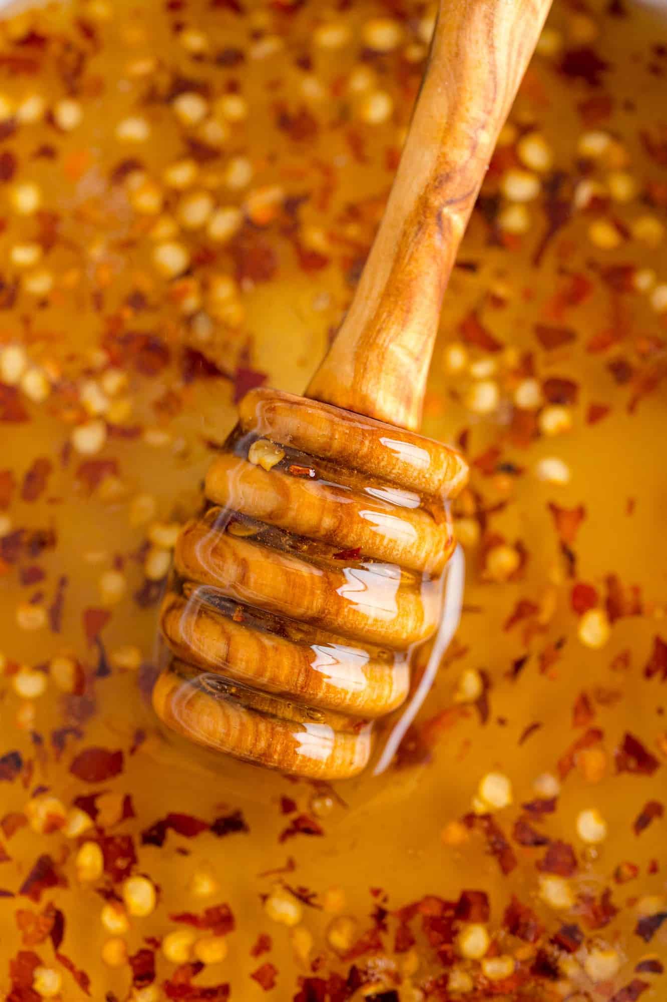 Close up of hot honey and honey dipper.