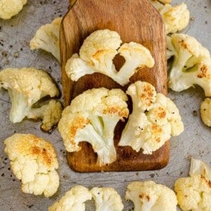 Roasted cauliflower on a wooden spatula.