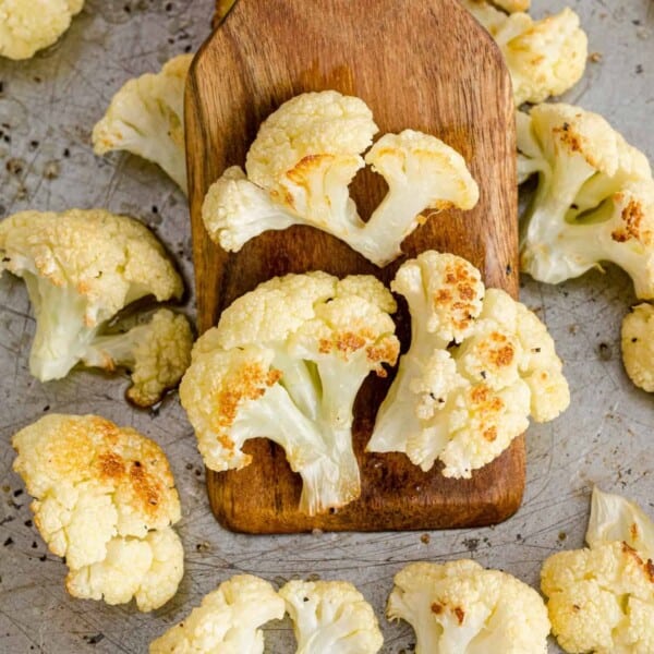 Roasted cauliflower on a wooden spatula.
