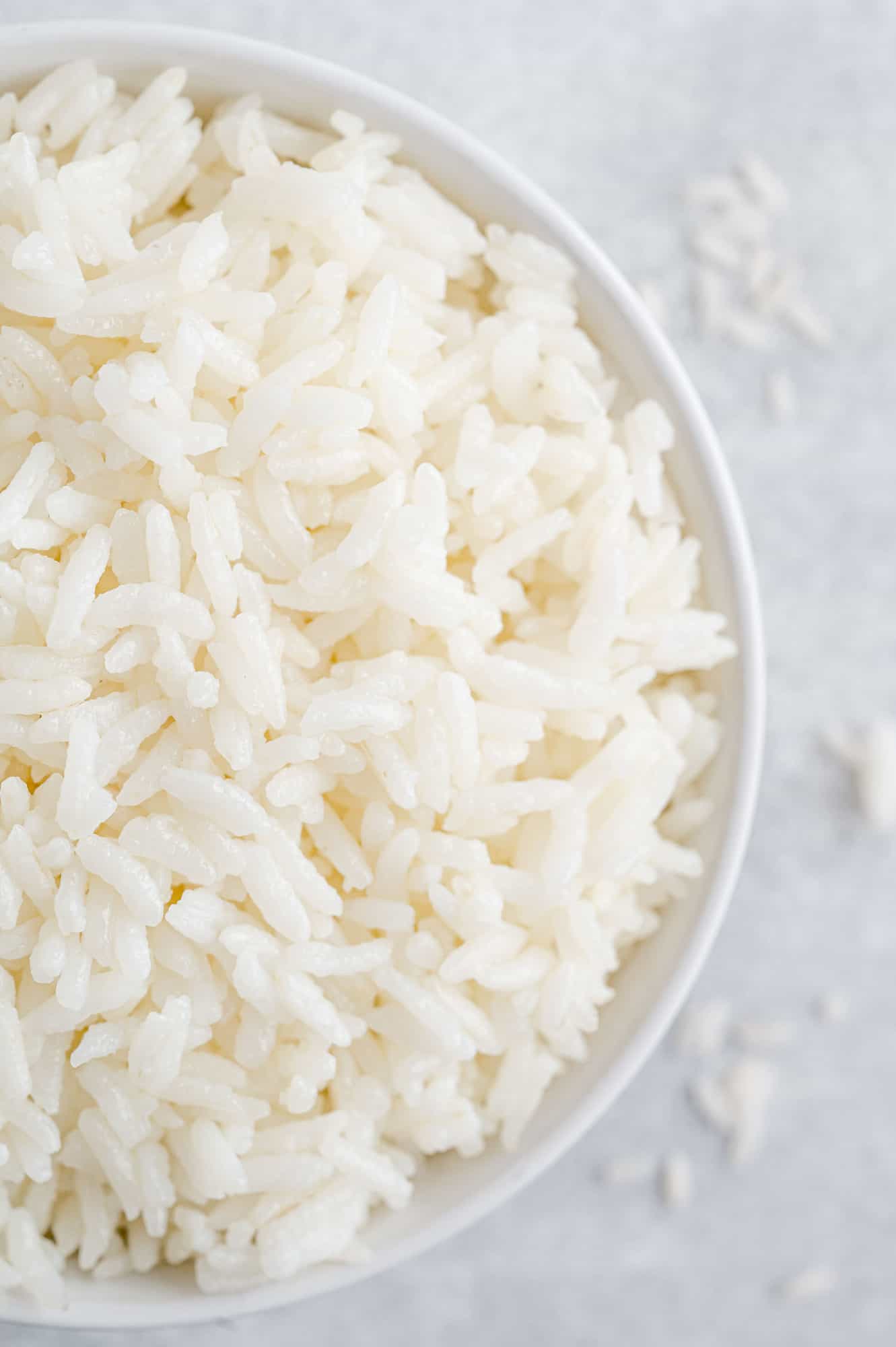 Overhead view of fluffy white rice in a bowl.