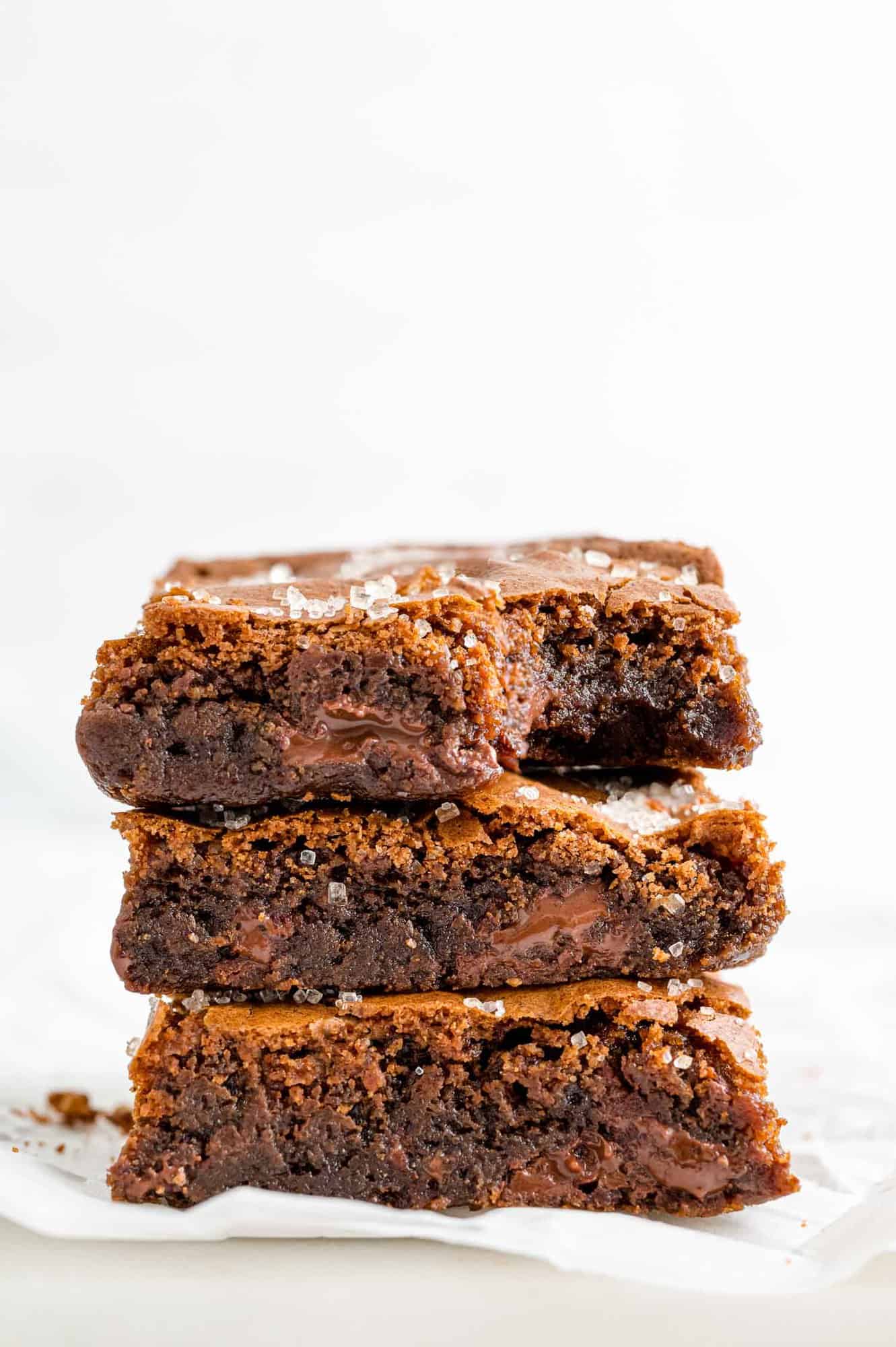 Stack of three kahlua brownies on a white background.