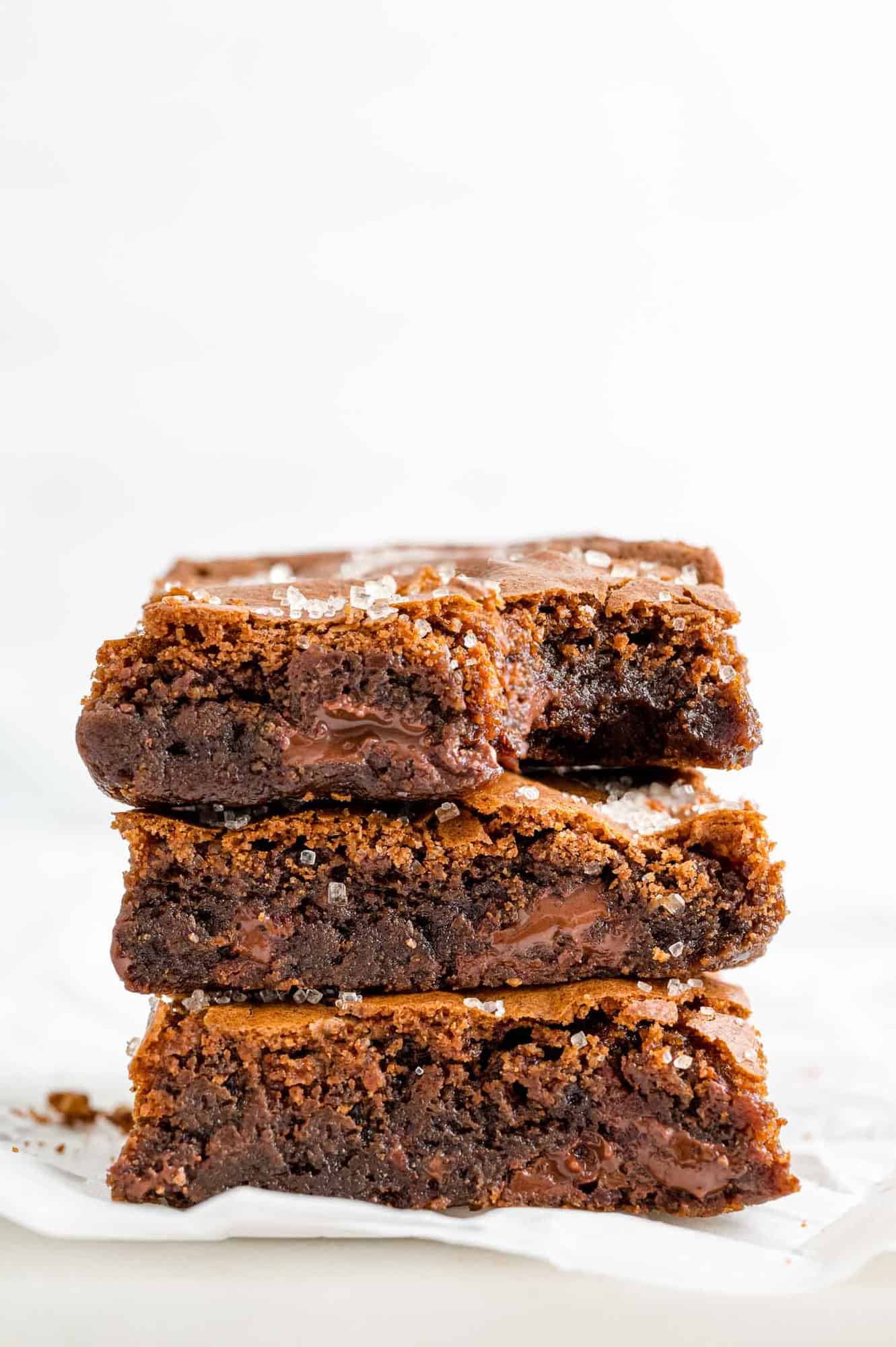 kahlua-cinnamon-brownies-gooey Stack of three kahlua brownies on a white background.