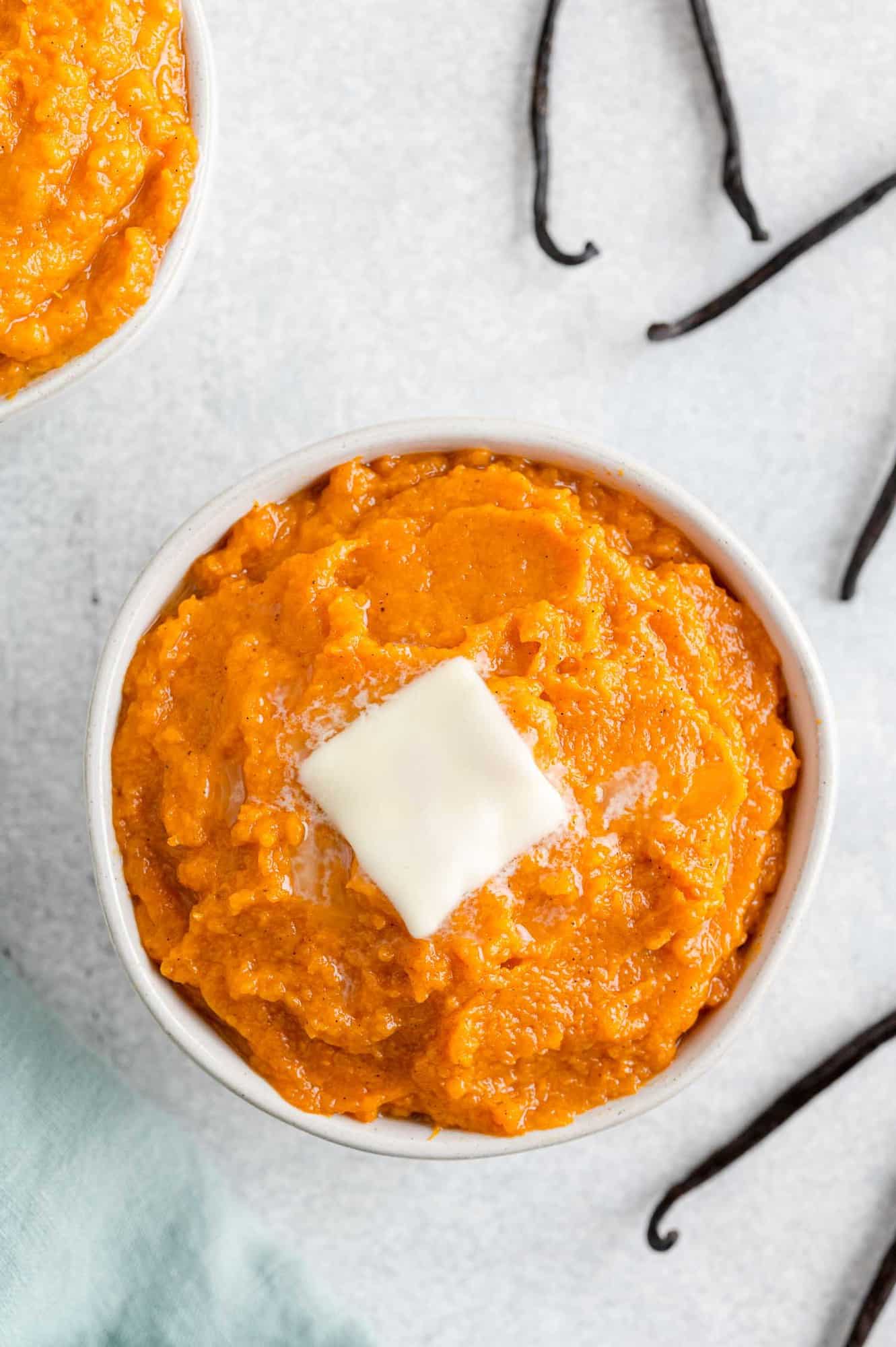 Vanilla bean mashed sweet potatoes in white bowl.