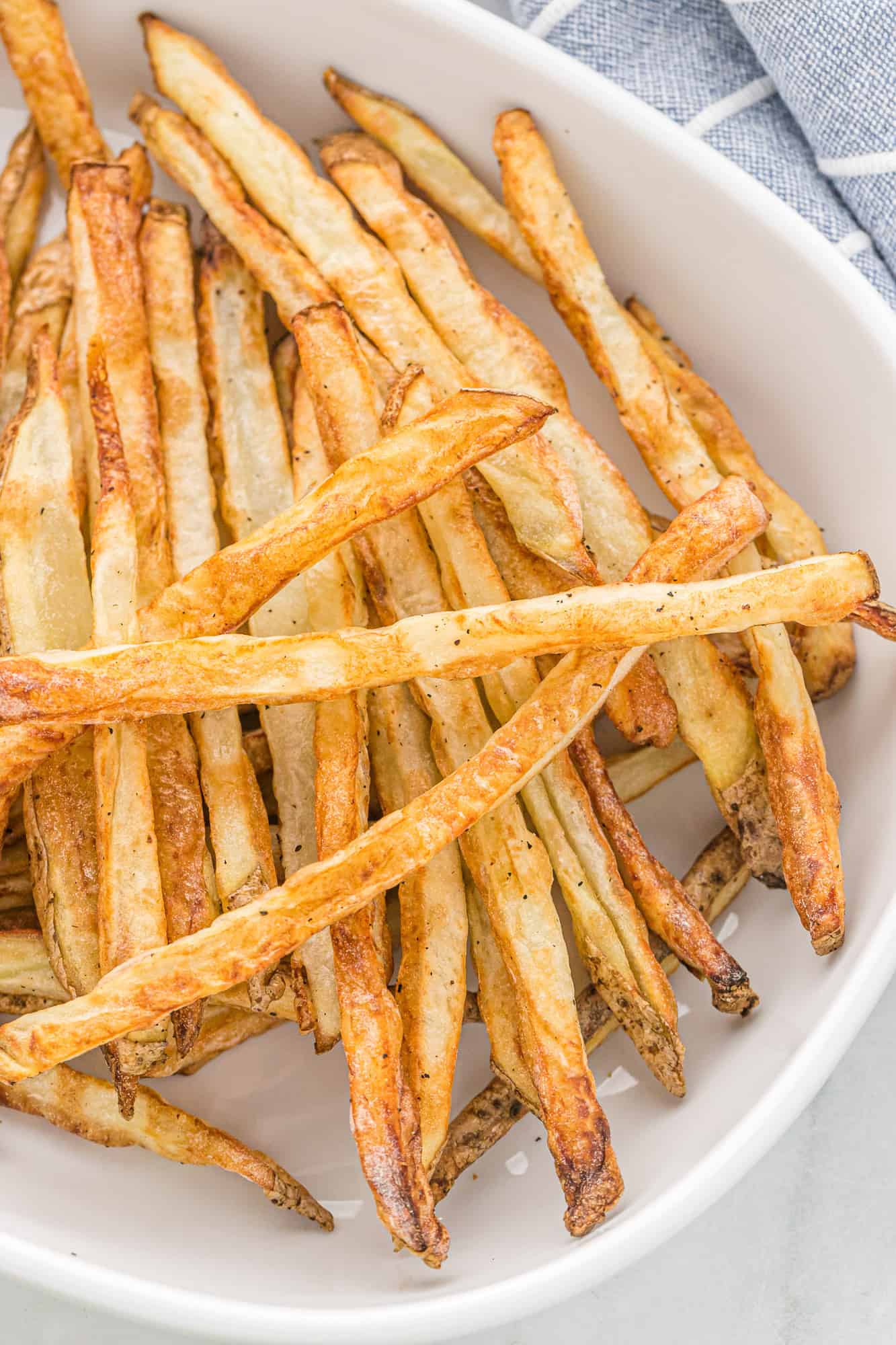 Close up view of fries in a white dish.