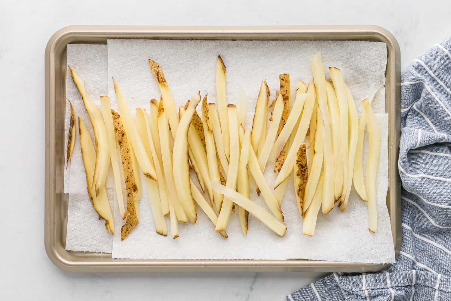 Uncooked fries being dried.
