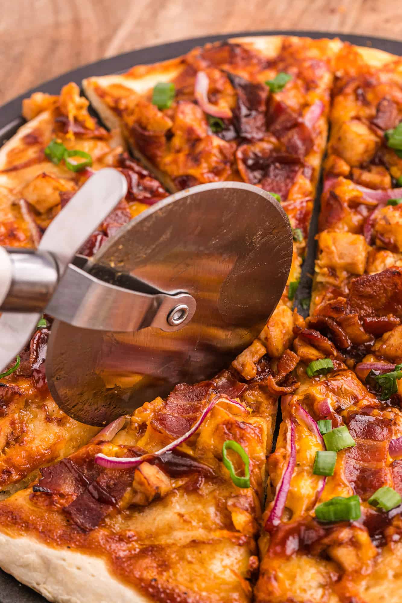 Pizza being sliced.