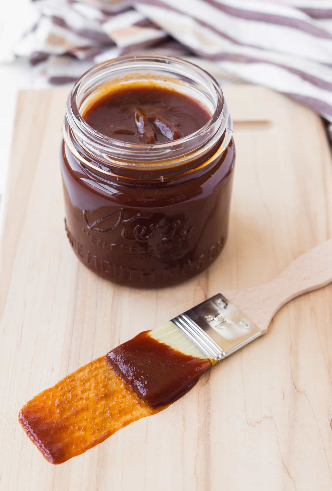BBQ sauce in a jar and on a brush.
