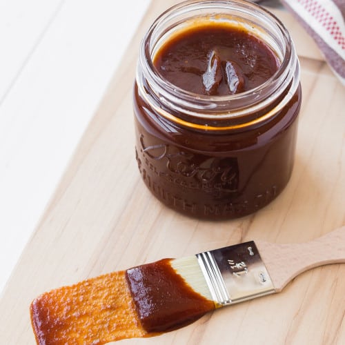 BBQ sauce in a jar and on a brush.