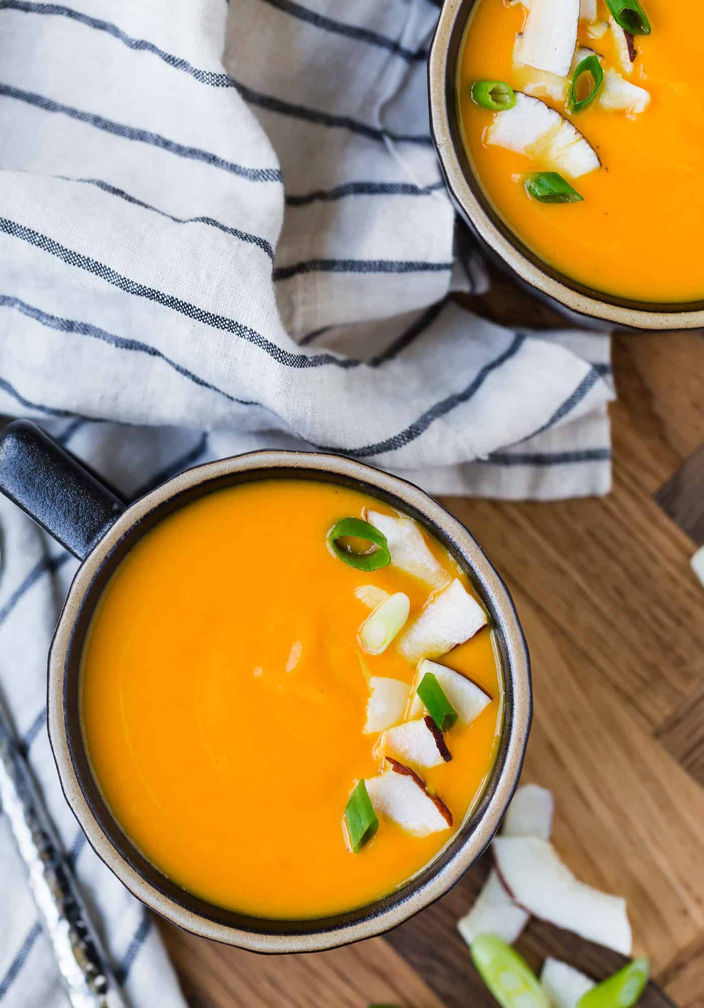 Overhead view of bright orange carrot soup.