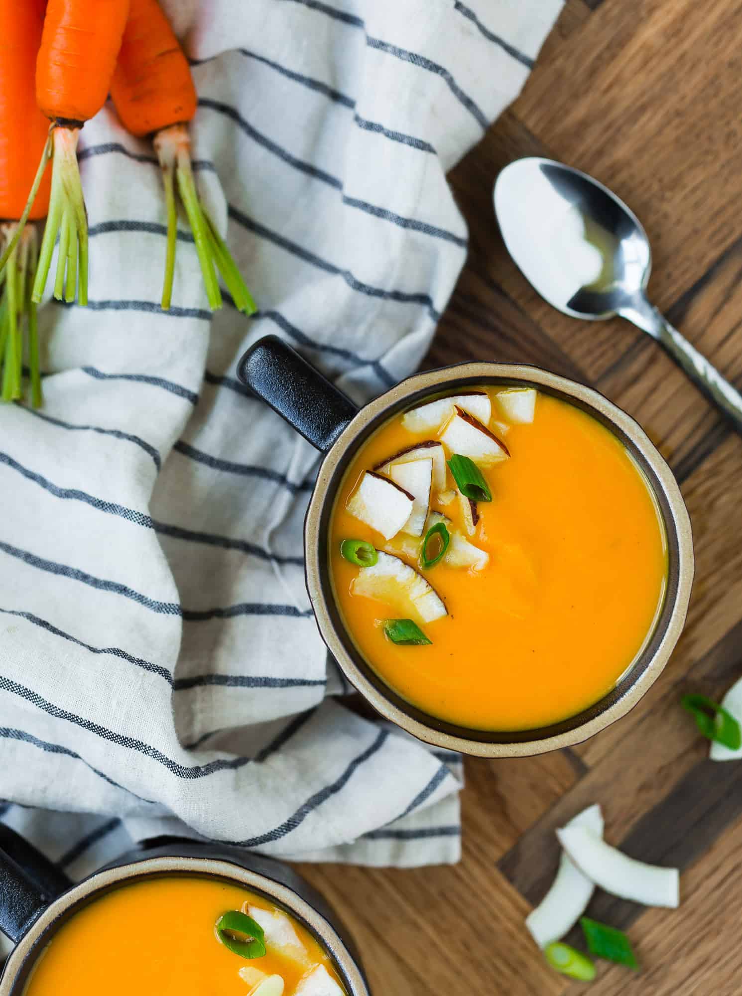 Overhead view of carrot ginger soup garnished with coconut.