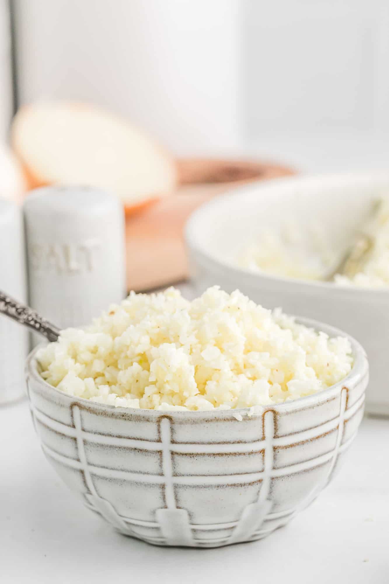 Cauliflower rice in a small black and white bowl.