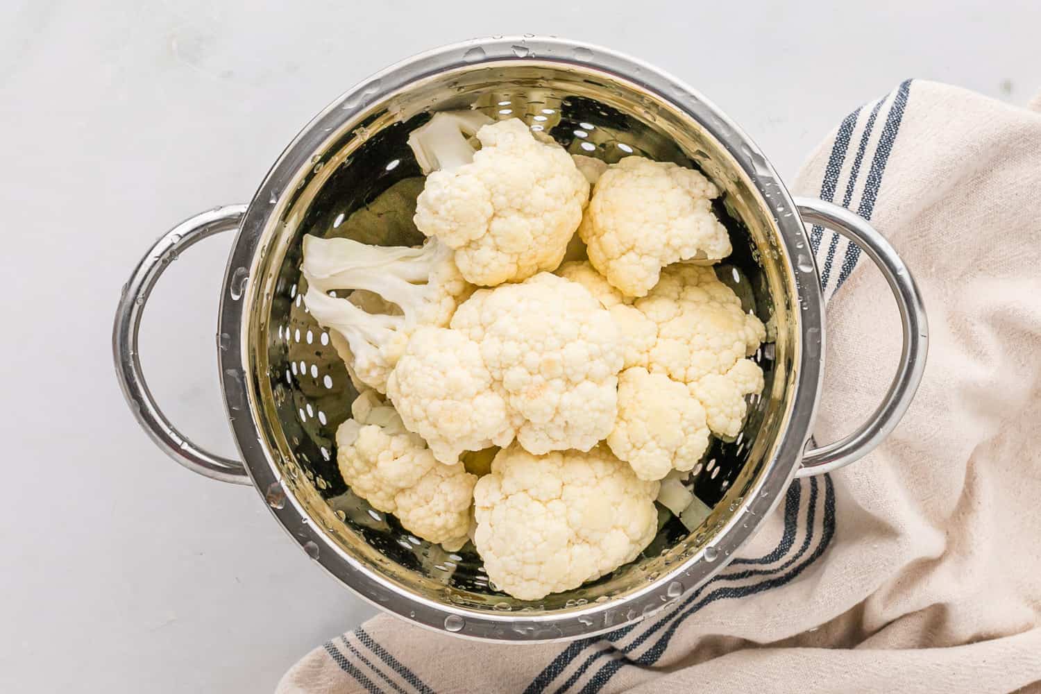 Cauliflower florets in a colander.