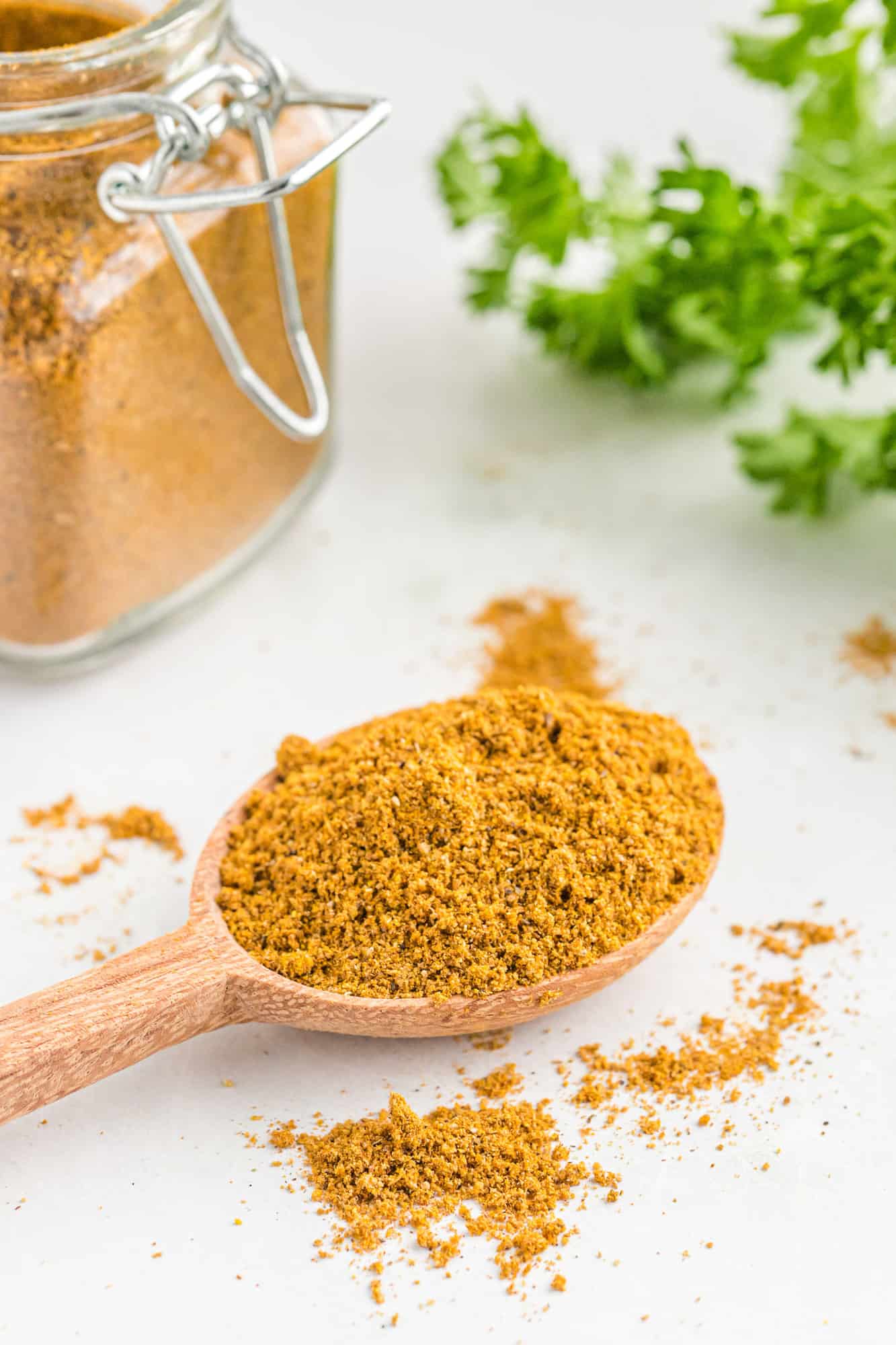 Curry powder on a small wooden spoon.