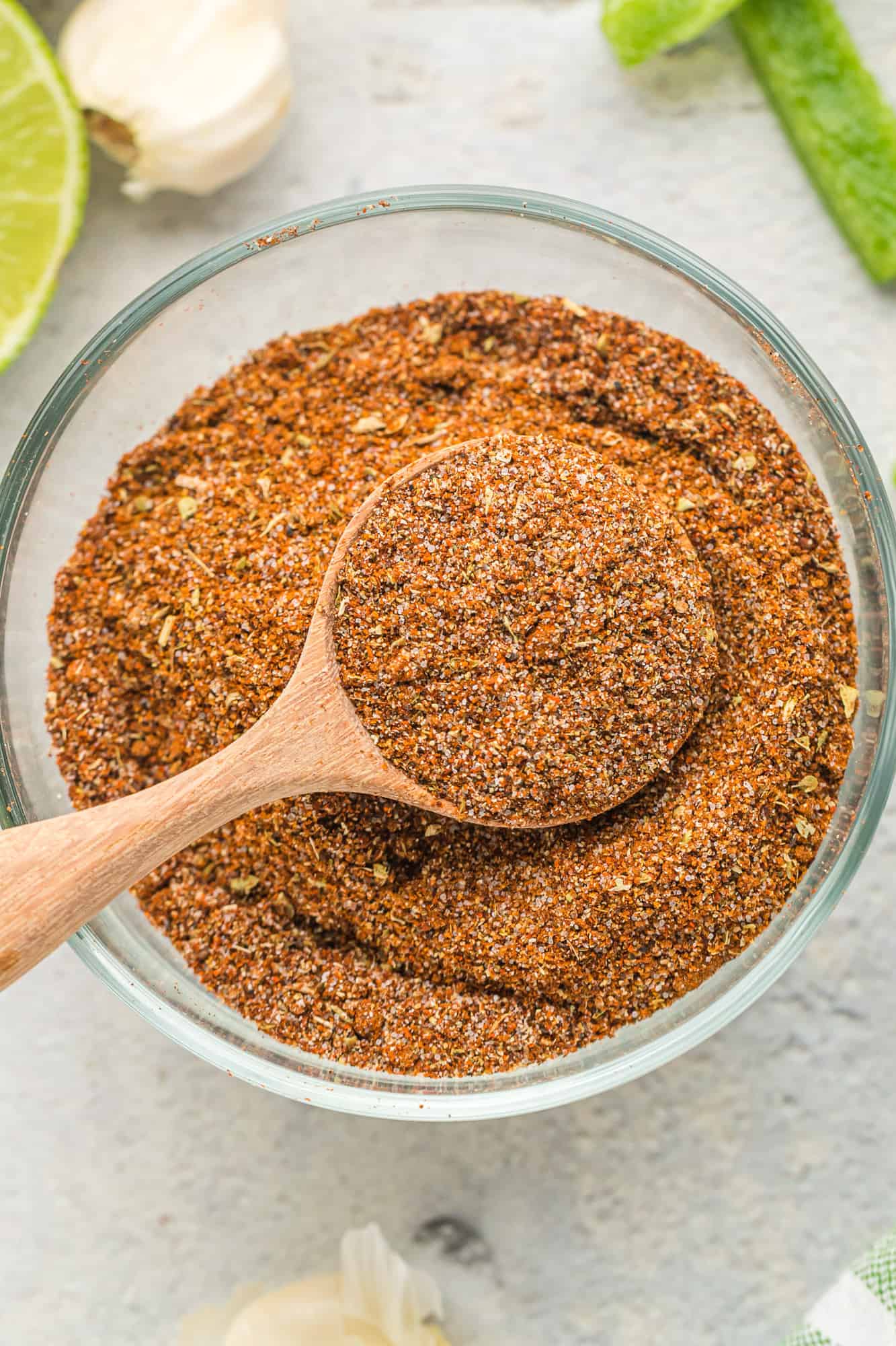 Fajita seasoning in a jar and on a wooden spoon.