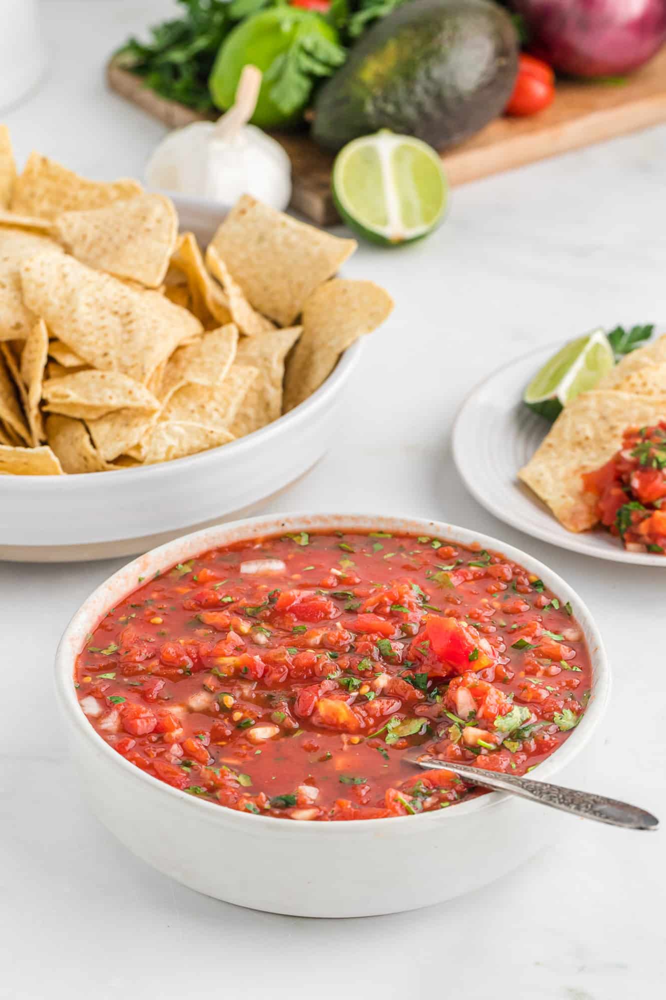 Salsa with chips in the background.