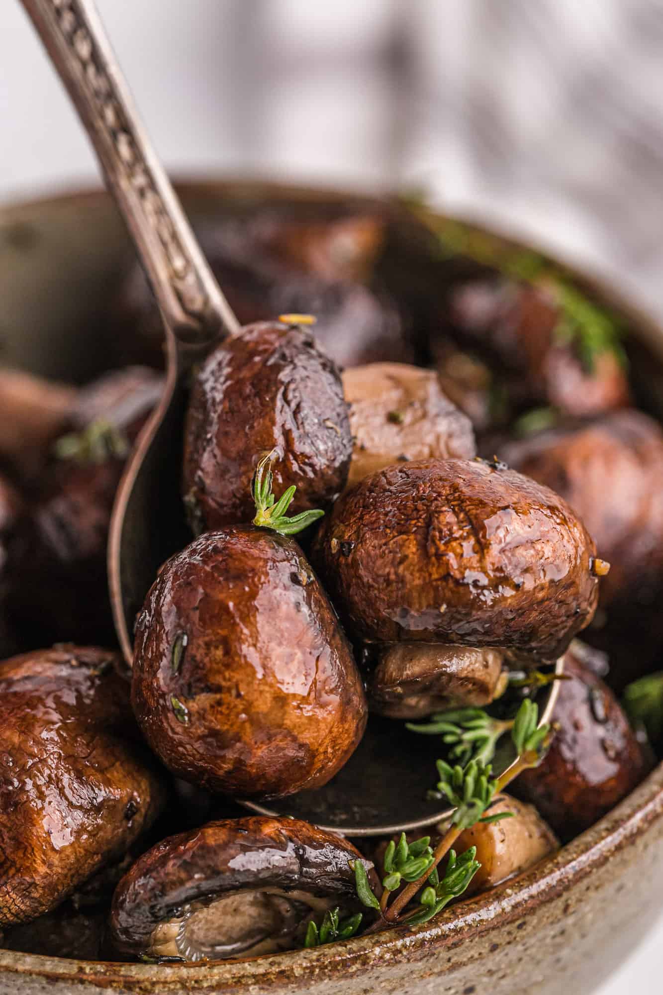 Cooked mushrooms on a serving spoon.